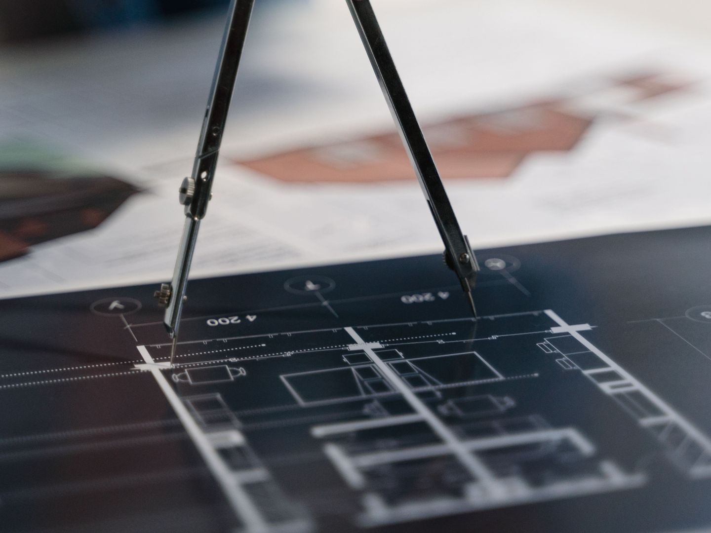 Drafting compass on technical drawings